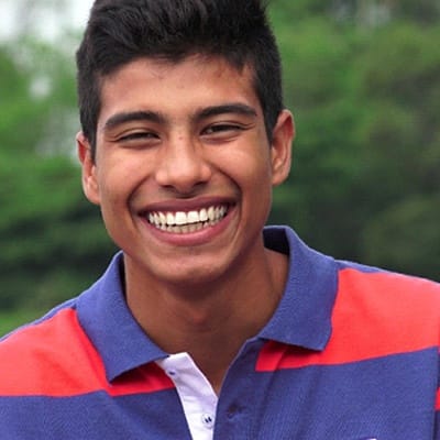 a male teenager smiling