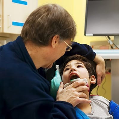 Dentist examining child's smile