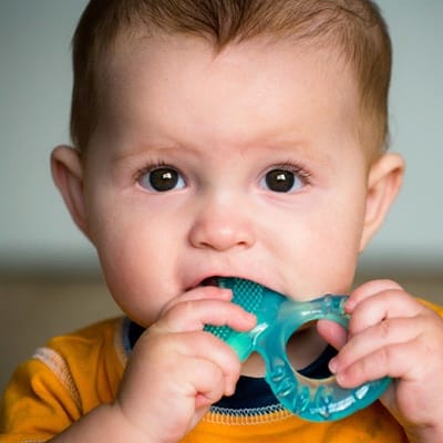 A baby chewing on a teether
