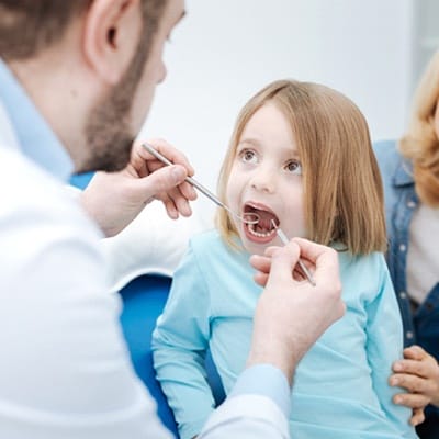 Little girl getting an oral cancer screening