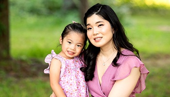 Dr. Justin and wife walking with daughter