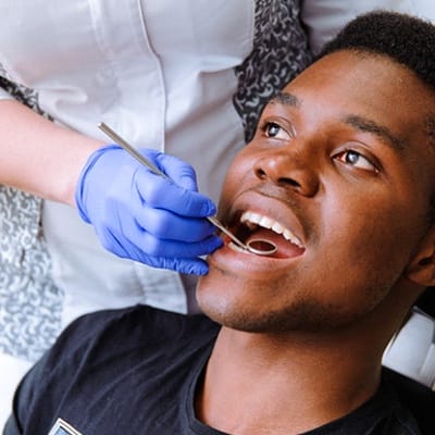 A male teenager receiving a dental checkup