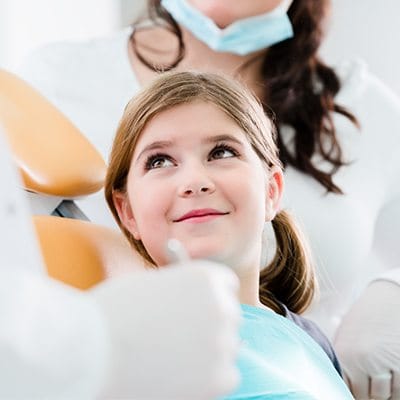 Smiling girl in dental chair