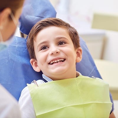Little boy in dental chair smiling