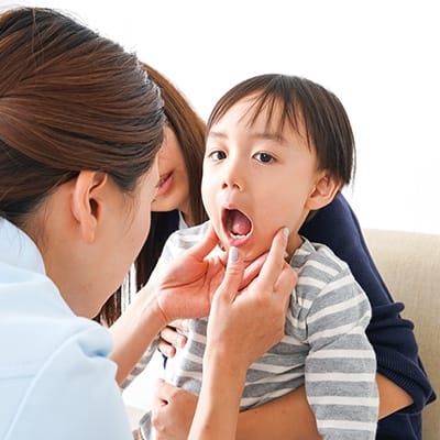 Child receiving oral cancer screening