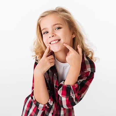 Little girl pointing to her smile