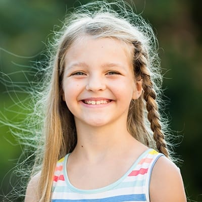 Young girl smiling outdoors