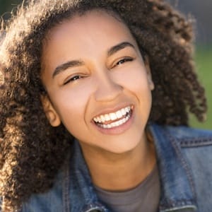 A young female with a bright, shining smile