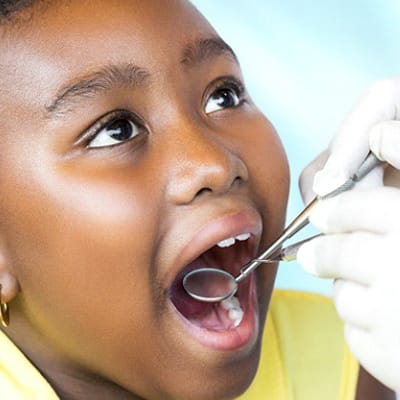 A young girl having her teeth checked