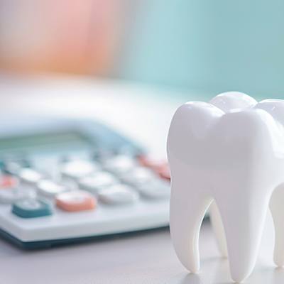  Large model tooth next to blurry calculator