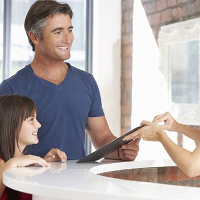 father and daughter smile while learning about the cost of dentistry