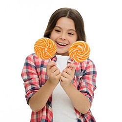 Girl holding two orange lollipops