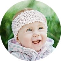 Smiling baby girl in pink jacket