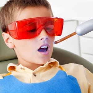 A young boy in the dentist chair