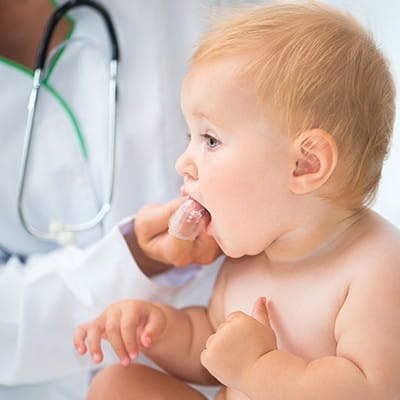 Dentist checking baby's teeth