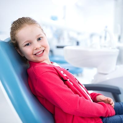 Smiling little girl in dental chair