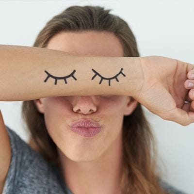 Woman covering her eyes with her arm