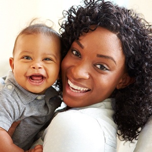 A mother and baby happy and smiling after identifying common symptoms of lip and tongue tie in McKinney and prepare for treatment