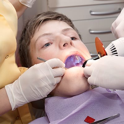 Teen boy receiving dental sealants