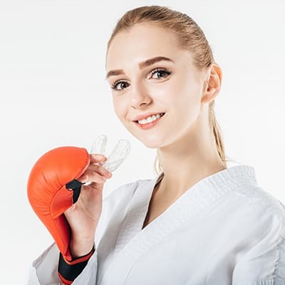 Young girl placing sports mouthguard