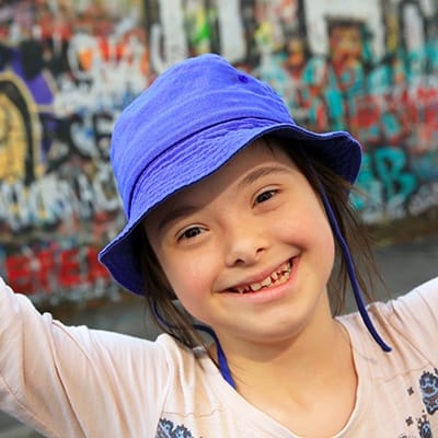 Smiling young girl with blue hat