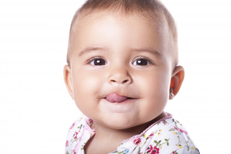 a baby sticking its tongue out