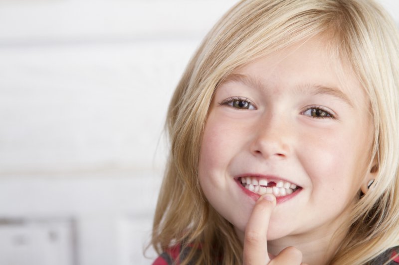 a little girl with a missing tooth