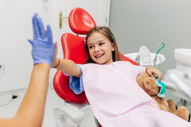 a little girl seeing a dentist who offers children’s dentistry in McKinney
