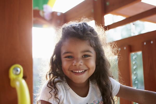 young girl smiling in play gym