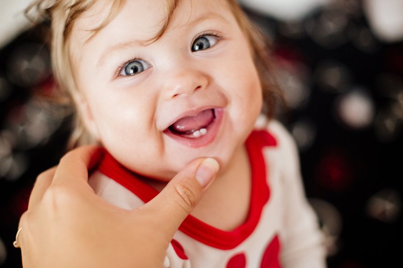 A baby showing teeth