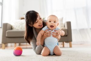 a parent holding their smiling infant