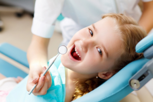 a child smiling while visiting the dentist